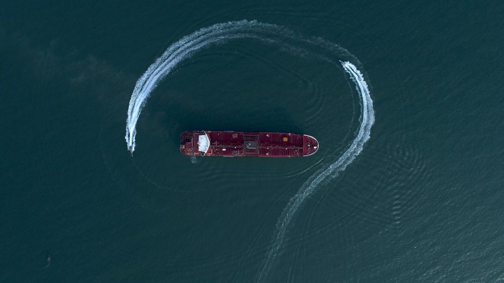 AP / Tasnim News Agency / Morteza Akhoondi 2019 © FILE - In this July 21, 2019 file photo, an aerial view shows a speedboat of Iran's Revolutionary Guard moving around the British-flagged oil tanker Stena Impero, which was seized in the Strait of Hormuz by the Guard, in the Iranian port of Bandar Abbas