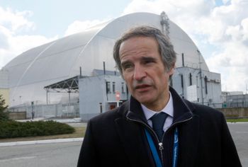 Director general of the International Atomic Energy Agency, Rafael Mariano Grossi, in front of a shelter construction which covers the exploded reactor at the Chernobyl nuclear plant, in Chernobyl, Ukraine, April 27, 2021.