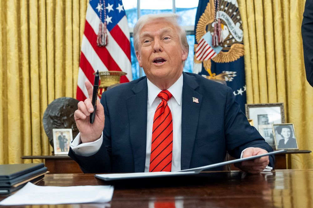 US President Donald Trump speaks with reporters as he signs executive orders in the Oval Office at the White House, in Washington, DC

