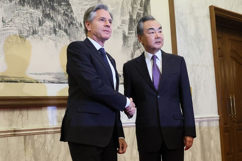 U.S. Secretary of State Antony Blinken (L) shakes hands with China's Director of the Office of the Central Foreign Affairs Commission Wang Yi in Beijing, China.