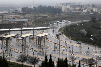 Tourist busses wait in the Tunnels Road checkpoint, near the West Bank town of Beit Jala