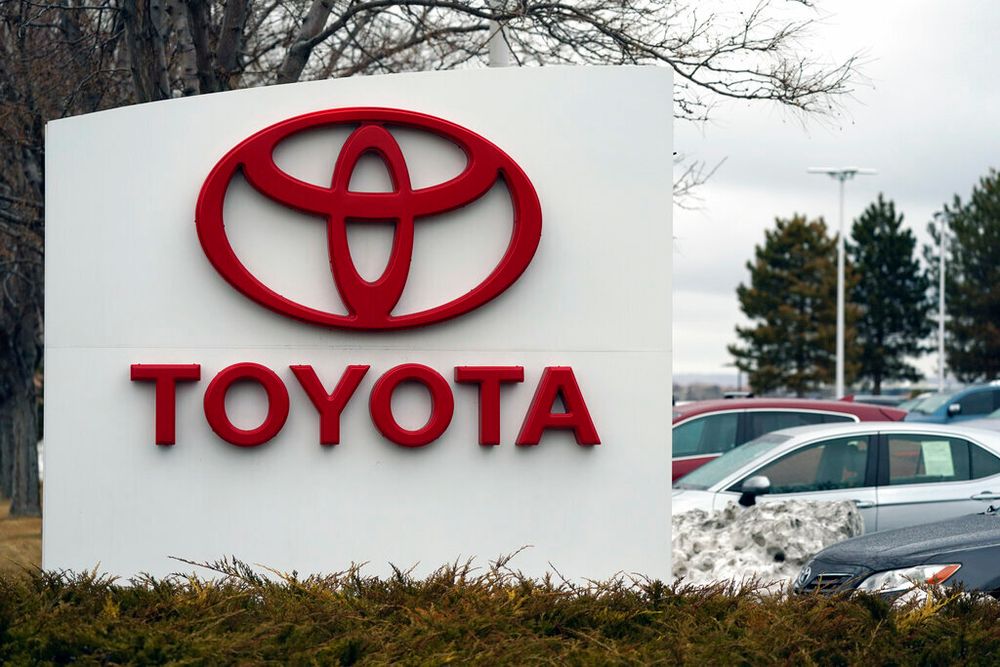 FILE - In this Sunday, March 21, 2021, photo, the company logo adorns a sign outside a Toyota dealership in Lakewood, Colorado.