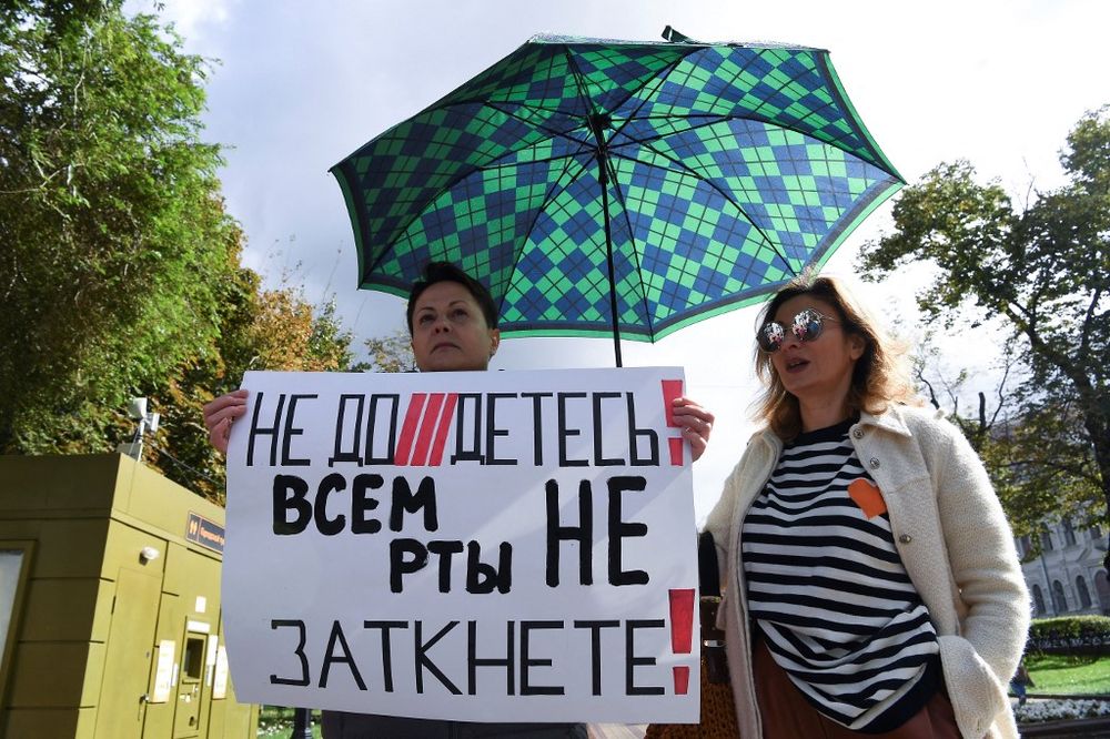 A woman holds a placard reading "You can't shut up everyone!" as journalists and supporters take part in a protest against the list of "foreign agent" media in central Moscow, Russia, on September 4, 2021.