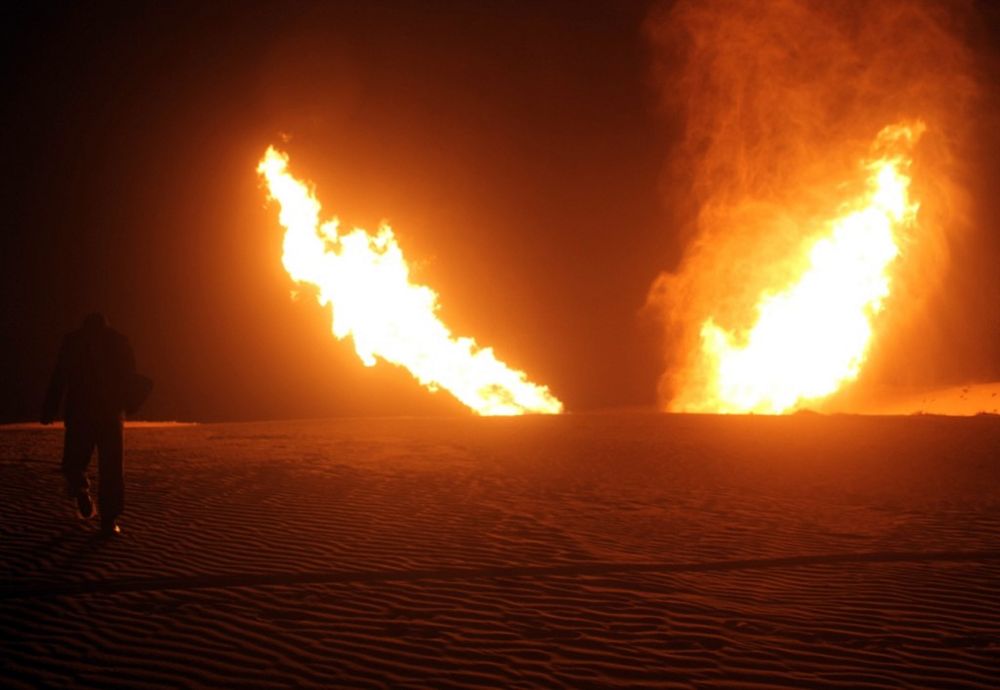 Flames raise from a pipeline that delivers gas to Israel and Jordan after it was hit during a separate, earlier incident by an explosion in the Al-Massaeed area, in north Sinai, Egypt, on March 5, 2012.