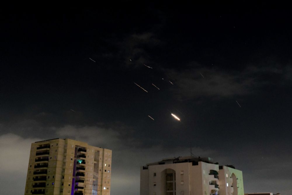 Anti-missile system fires interception missiles as drones and missiles fired from Iran, as it seen over Tel Aviv.