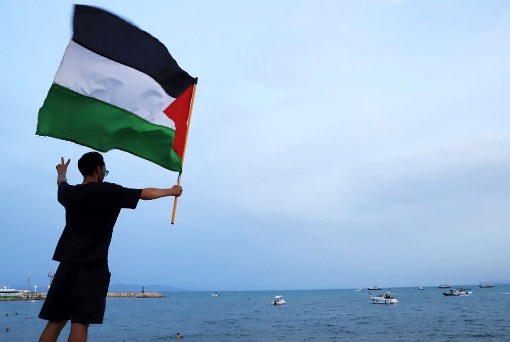 AP Photo/Anis Mili A protester waves a Palestinian flag in support of the the Global Sumud Flotilla as it arrives at the port of Sidi Bou Saïd, in Tunis, Tunisia, Sunday, Sept. 7, 2025.