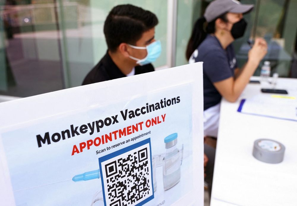 Health workers sit at a check-in table at a pop-up monkeypox vaccination clinic in West Hollywood, California, the United States, on August 3, 2022
