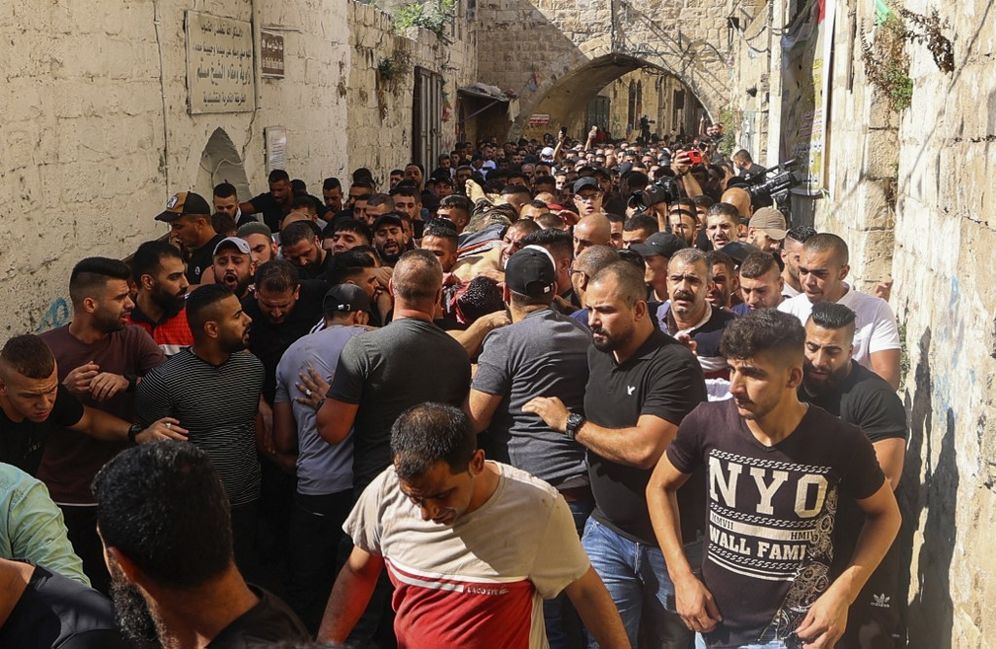 Palestinians evacuate an injured gunman following a raid by Israeli forces of a house in Nablus in the West Bank, on August 9, 2022.