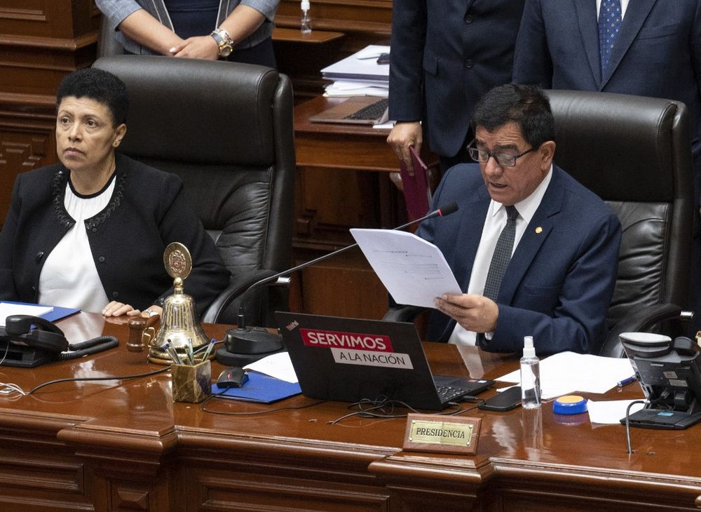 President of the Peruvian Congress Jose Williams Zapata (R) reads the vote result to impeach President Pedro Castillo in Lima, Peru, on December 7, 2022.