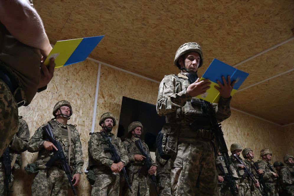 In this photo provided by Ukraine's 65th Mechanized Brigade press service, recruits take the oath at the frontline in the Zaporizhzhia region, Ukraine, Sunday, Aug. 23, 2026