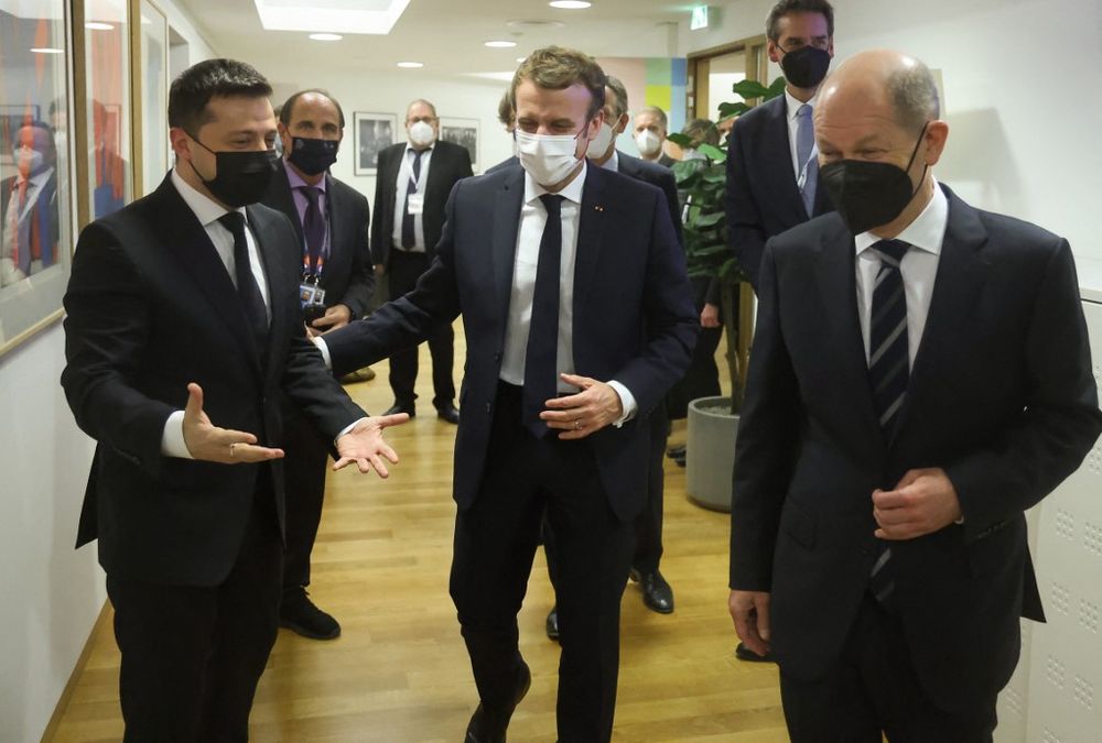 Germany's Chancellor Olaf Scholz (R), France's President Emmanuel Macron (C) and Ukraine's President Volodymyr Zelensky (L) at The European Council Building in Brussels, Belgium on December 15, 2021.