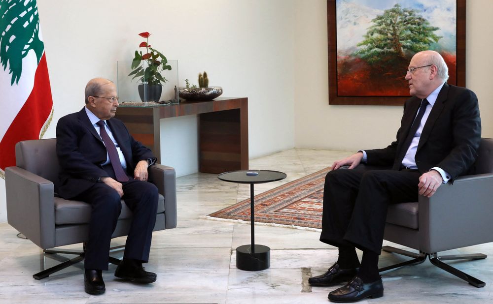 Lebanon's President Michel Aoun (L) meeting with Prime Minister Najib Mikati (R) at the presidential palace in Baabda, east of the capital Beirut, on April 7, 2022.