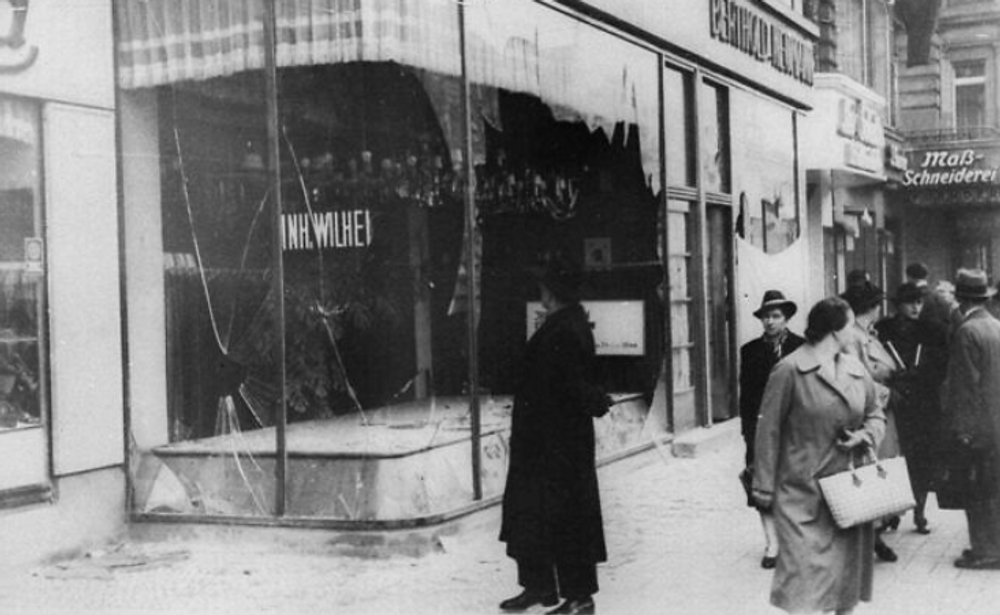 Un homme regarde la vitrine brisée d'un magasin juif à Berlin le 10 novembre 1938, au lendemain de la Nuit de cristal.