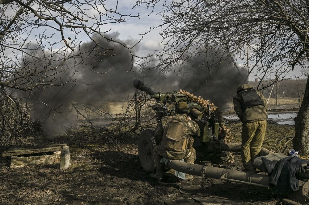 Ukrainian servicemen fire a 105mm Howitzer towards Russian positions, near the city of Bakhmut.
