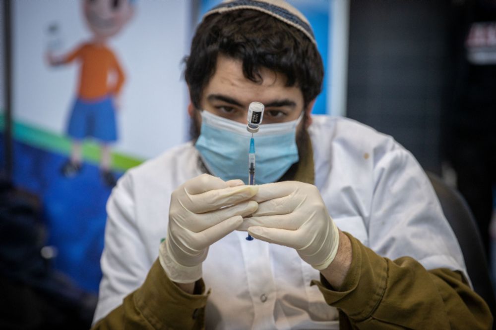 A medical worker prepares a COVID-19 vaccine injection, at a vaccination center in Jerusalem, on March 8, 2021.