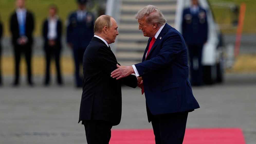 AP Photo/Julie Demaree Nikhinson Putin and Trump shaking hands in Alaska