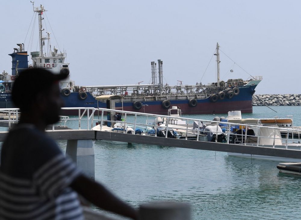 A man watches ships' movement in the port of Fujairah in the east of the United Arab Emirates on July 2, 2019.