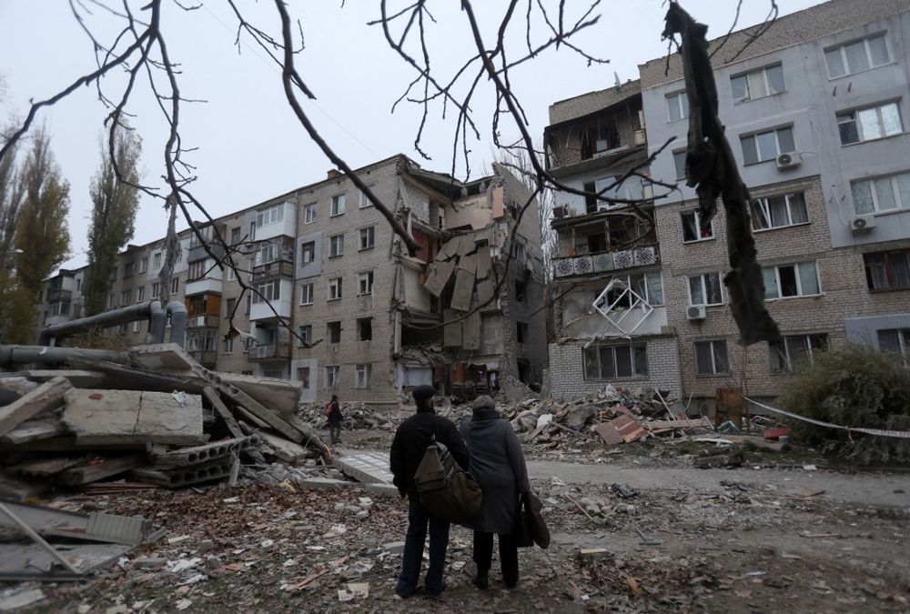 Local residents look at a damaged five-store residential building after a strike in Mykolaiv, Ukraine.