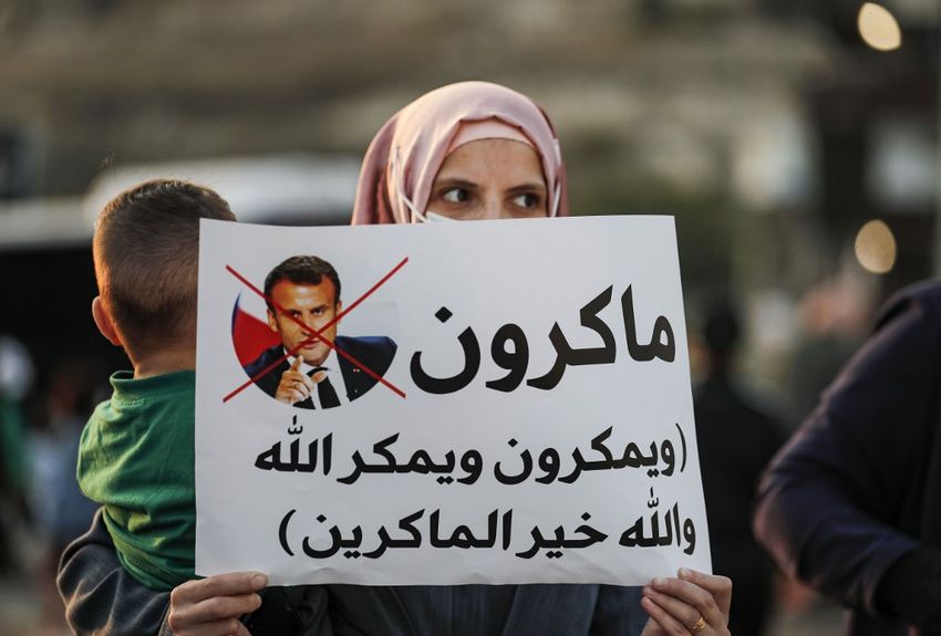 فتاة عربية من مدينة أم الفحم في إسرائيل ترفع لافتة خلال مسيرة احتجاجية على تعليقات الرئيس الفرنسي إيمانويل ماكرون على الرسوم الكاريكاتورية للنبي محمد، شمال إسرائيل، 25 أكتوبر، 2020.