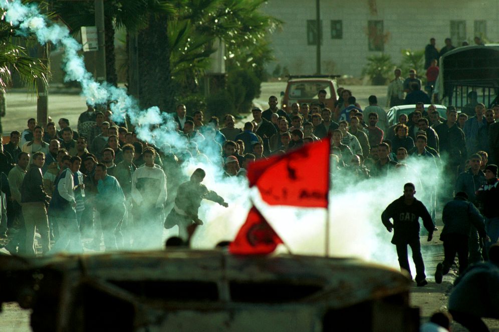 FILE2000** Palestinians shoot tear gas at the Israeli army in Ramallah, as they clash during the first days of the Second Intifada. The intifada was the second Palestinian uprising, a period of intensified Palestinian-Israeli violence, which began in late September 2000. October 24, 2000. 