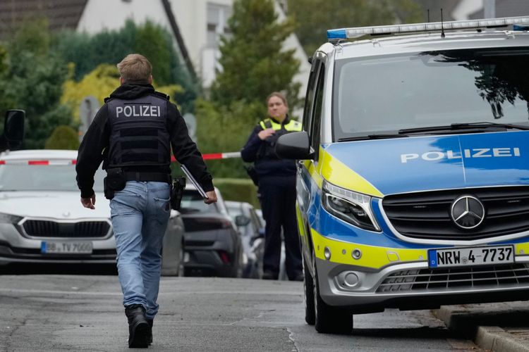 A police officer crosses a street in Herdecke, Germany
