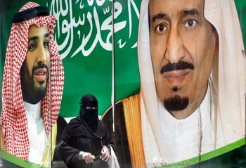 A banner showing Saudi King Salman (R) and Crown Prince Mohammed bin Salman hangs outside a mall in Jeddah, Saudi Arabia, on June 15, 2020.