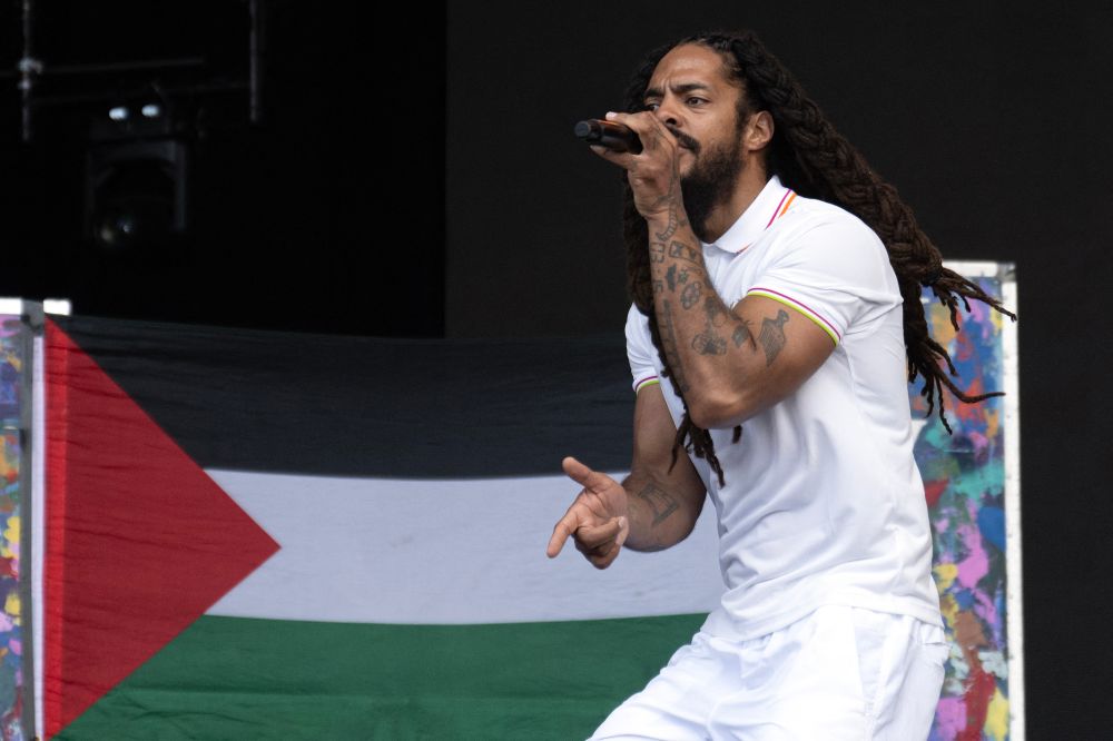 To the backdrop of a Palestinian flag, Bobby Vylan of British duo Bob Vylan performs on the West Holts Stage on the fourth day of the Glastonbury festival
