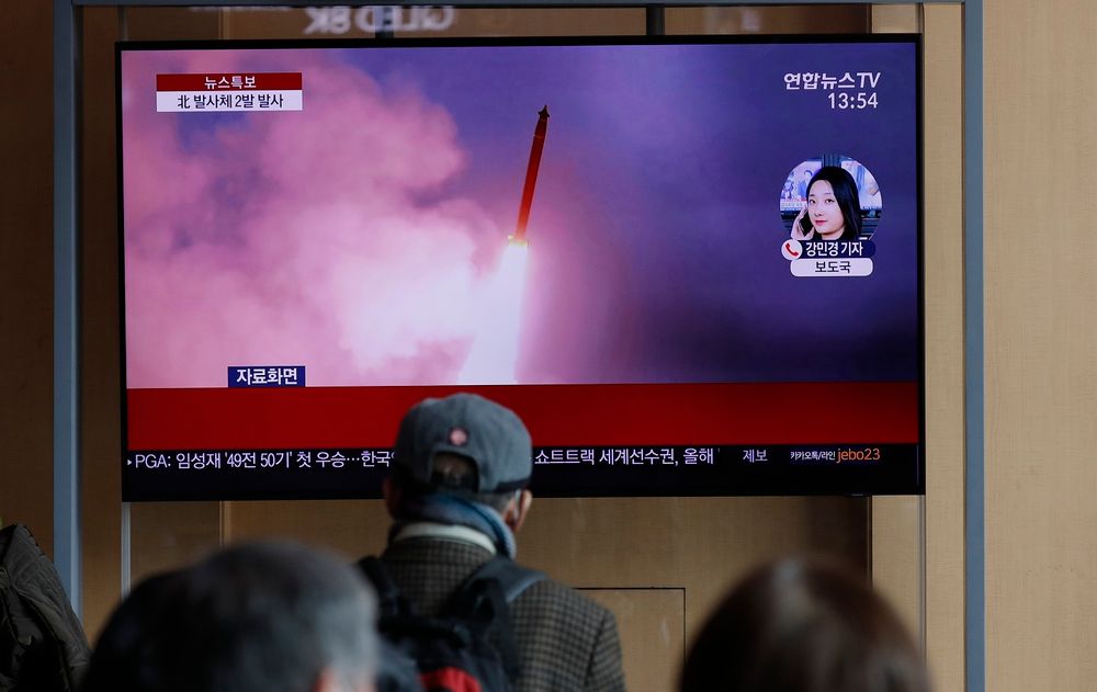 People watch a TV screen showing a news program reporting about North Korea's firing of projectiles with a file image at the Seoul Railway Station in Seoul, South Korea, Monday, March 2, 2020