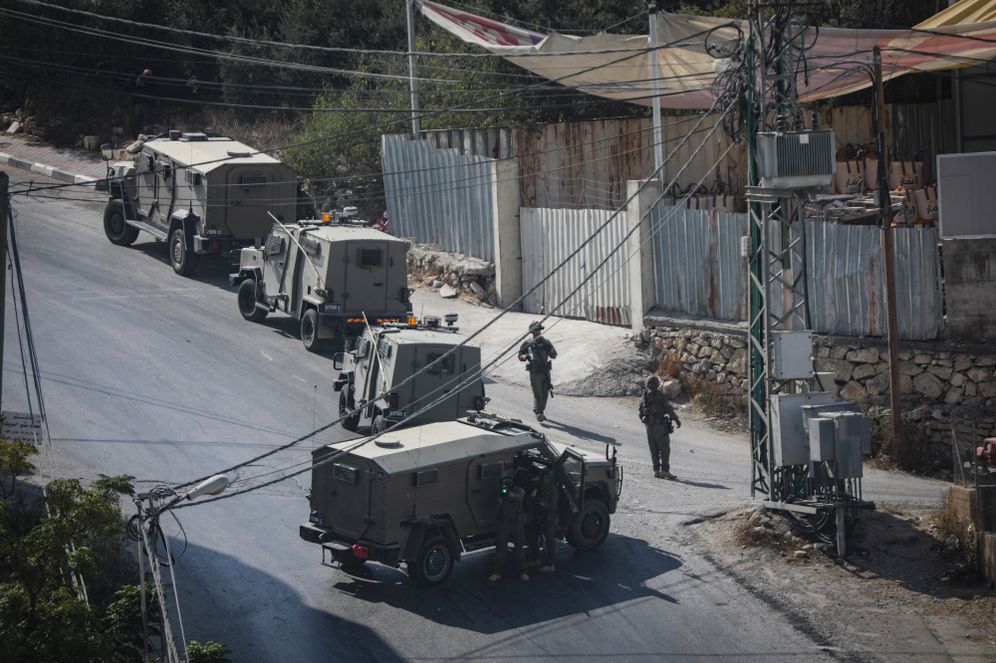 Israeli soldiers take part in a military operation in the West Bank city of Hebron following a shooting attack in the area earlier in the day, October 23, 2026. 
