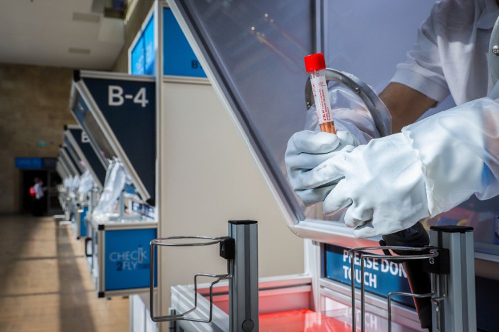 A medical technician holds a swab sample in the Covid lab at Ben Gurion International Airport, near Tel Aviv, Israel, on November 9, 2020.