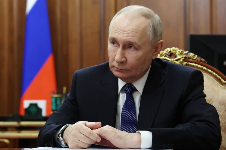 FILE - Russian President Vladimir Putin listens to Roman Artyukhin, the head of the treasury, at the Kremlin in Moscow, on Tuesday, March 3, 2026. 
