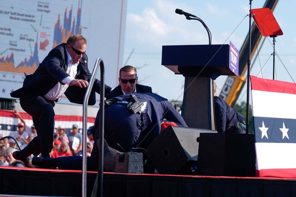 Former US president Donald Trump falling to the ground after a bullet grazed his ear in Bulter, Pennsylvania