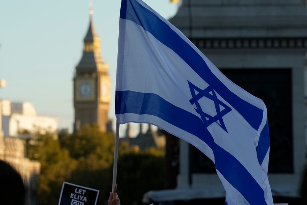 Israeli flags and placards are held during a protest in support of Israel in Trafalgar Square, London, United Kingdom.