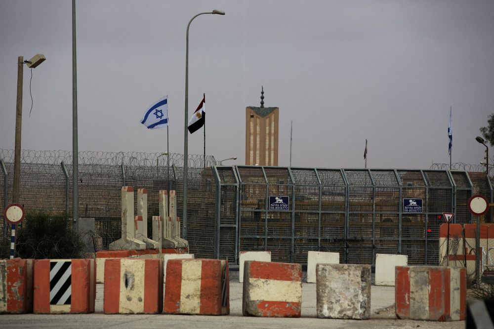 Israeli and Egyptian flags are seen in the Nitzana Border Crossing along the southern Israeli border with Egypt near the Israeli village of Nitzanei Sinai on August 20 2013.