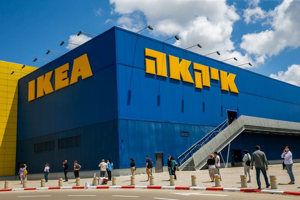 FILE - Israelis wait outside the IKEA branch in Netanya, after the company opened some of its branches in Israel, on April 26, 2020.