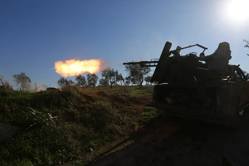 Turkish backed Syrian fighter fires at a frontline near the town of Saraqib in Idlib province, Syria, Wednesday, Feb. 26, 2020