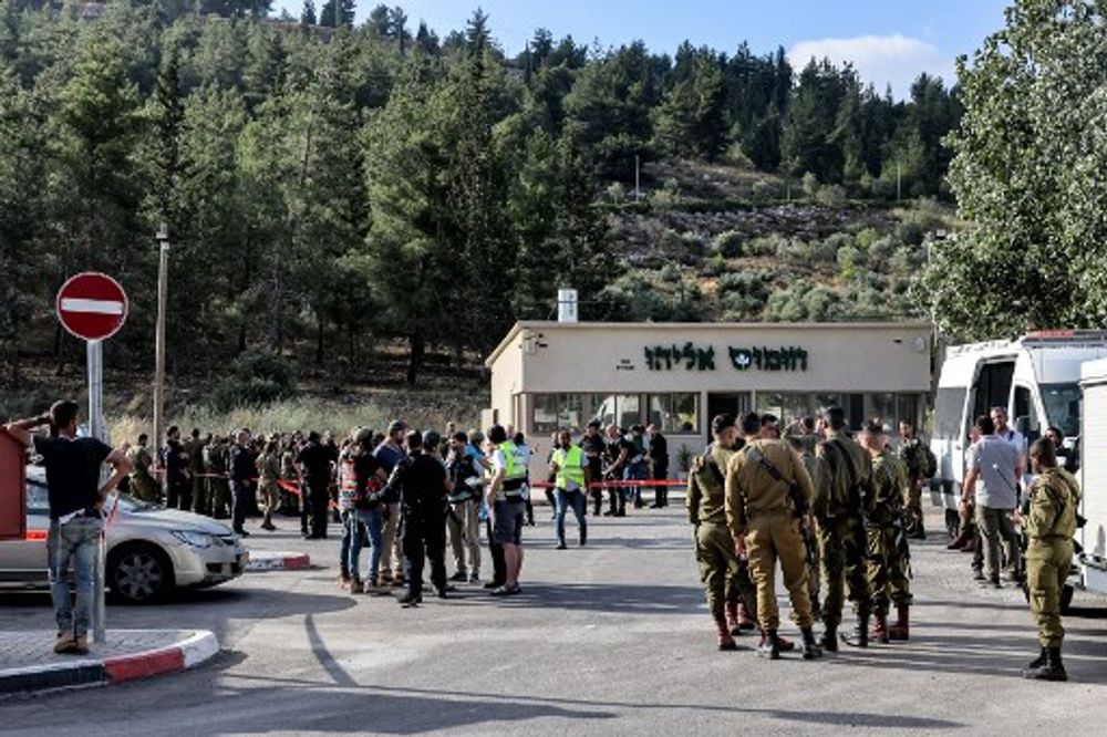 Israeli army and police forces gather at the scene of an attack near Eli, the West Bank.