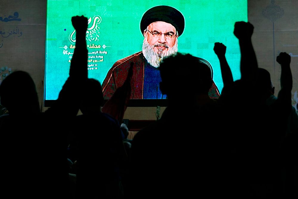 Supporters of Hezbollah cheer as they listen to a speech by the group's leader Sayyed Hassan Nasrallah via a video link in the southern Beirut suburb of Dahiyeh, Lebanon.
