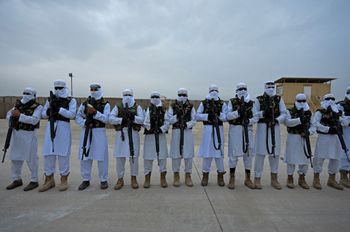 Taliban fighters stand guard during a military street parade in Maymana, Afghanistan, on January 16, 2022.