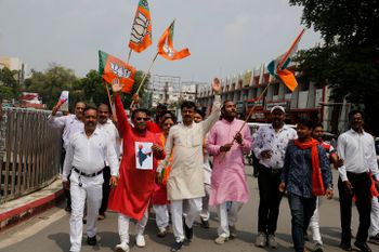 India's ruling Bharatiya Janata Party (BJP) supporters celebrate government revoking disputed Kashmir's special status in Prayagraj, India, Monday, Aug. 5, 2019.