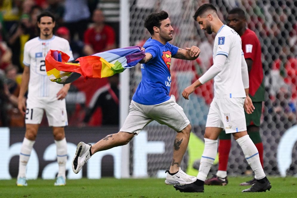 Kirill KUDRYAVTSEV / AFP A man rushes the field during a World Cup match between Portugal and Uruguay in Lusail, Qatar