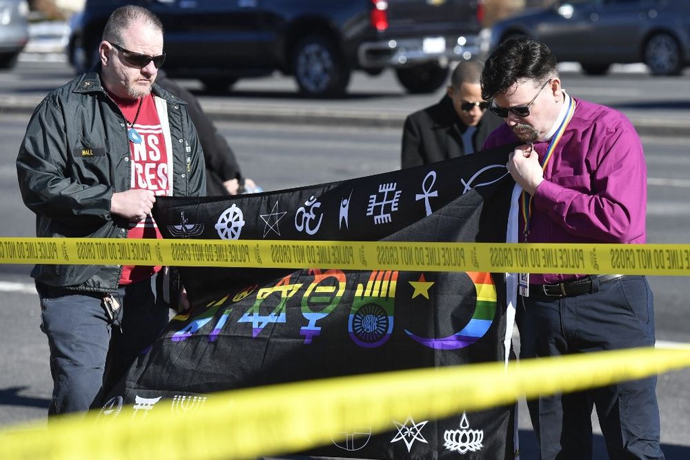 Michael I. Travis (L) and Dr. Michael R. Travis place a flag at a memorial for the victims of a mass shooting at Club Q, an LGBTQ nightclub, in Colorado Springs, the United States, on November 20, 2022.