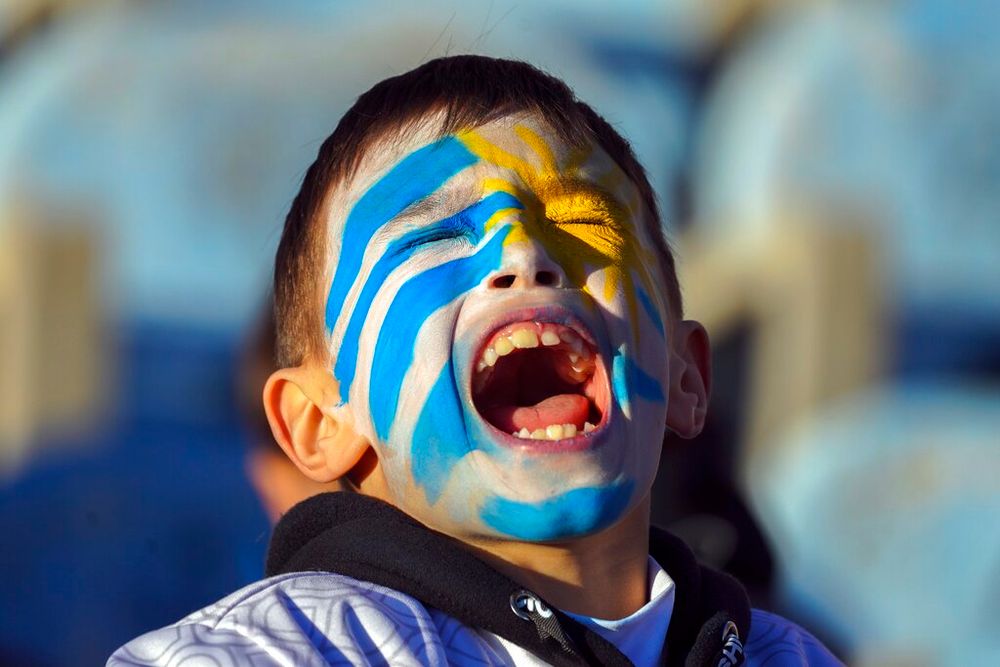 A young fan cheers for Uruguay's national soccer team before a friendly match, the last before going to the 2022 Qatar World Cup, in Montevideo, Uruguay, on June 11, 2022.