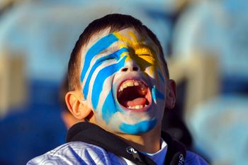 A young fan cheers for Uruguay's national soccer team before a friendly match, the last before going to the 2022 Qatar World Cup, in Montevideo, Uruguay, on June 11, 2022.