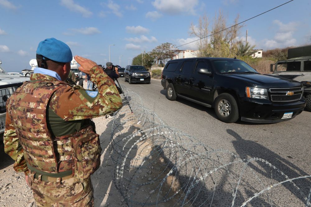 (File) A UN peacekeeper soldier, left, salutes a convoy bringing a Lebanese delegation to meet an Israeli delegation in the southern town of Naqoura, Lebanon