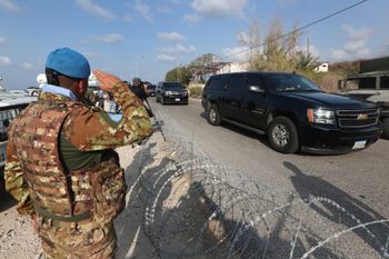 (File) A UN peacekeeper soldier, left, salutes a convoy bringing a Lebanese delegation to meet an Israeli delegation in the southern town of Naqoura, Lebanon