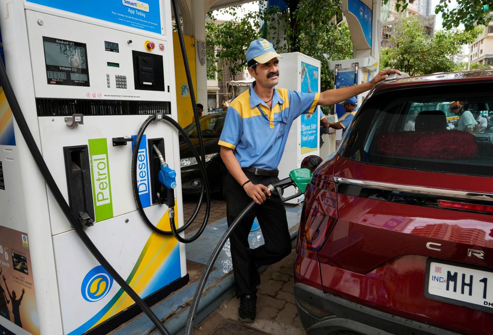 An employee of a Bharat petroleum fuel station fills petrol in a vehicle in Mumbai, India, Saturday, June 11, 2022