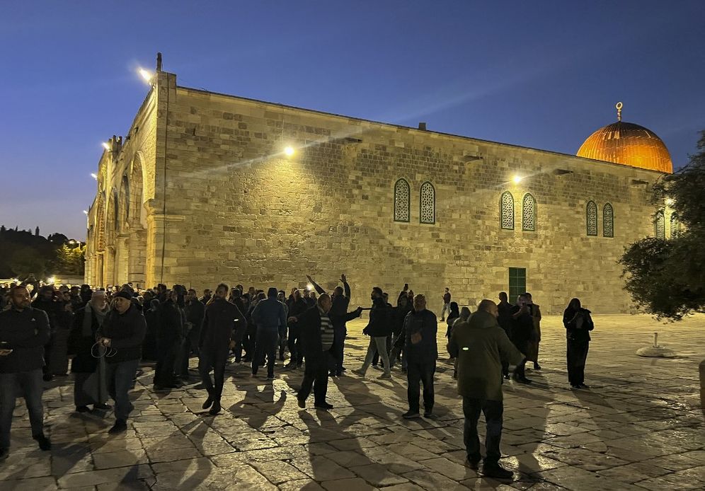 Palestinians shout at Israeli security forces at the Al-Aqsa Mosque compound in Jerusalem.