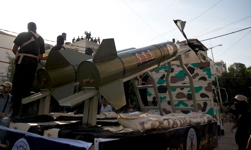 Members of the military wing of Islamic Jihad parade with a replica rocket to show loyalty for leader Ziad al-Nakhalah, Gaza, Thursday, Oct. 4, 2018.