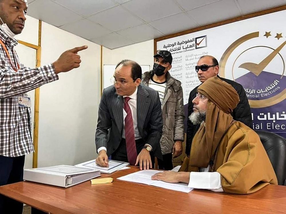 Seif al-Islam Kadhafi (L) registering to run in the country's December presidential polls, in Libya's southern city of Sebha, November 14, 2021.